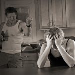 Mann bedroht weinende Frau am Küchentisch