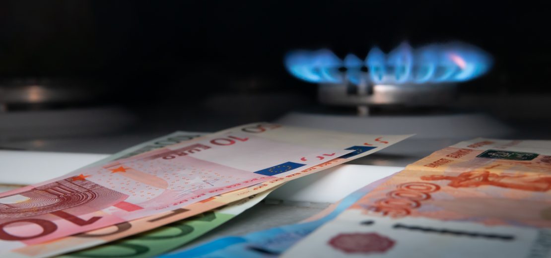 Geld im Vordergrund, Gasflamme im Hintergrund: Symbol für Energiesparen im Unternehmen