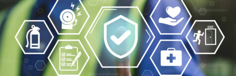 Mann mit Warnweste deutet auf Arbeitschutz-Symbole